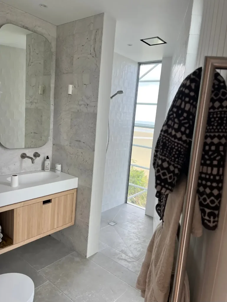 Modern bathroom renovation with glass shower doors and sleek fixtures by Bathroom renovations Cromwell.