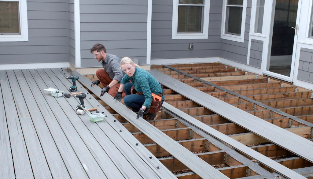 Couple expertly assembling a deck with Builders Cromwell, led by skilled Deck builders Cromwell.