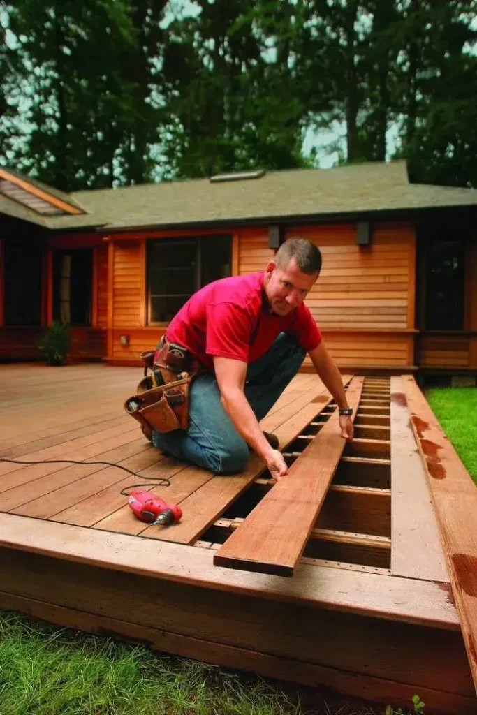 Craftsman installing timber boards, expertly done by Deck builders Cromwell at Builders Cromwell.